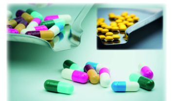 pastillas de distintos colores con fondo de venmir y el titulo el acero inoxidable y la industria farmaceutica